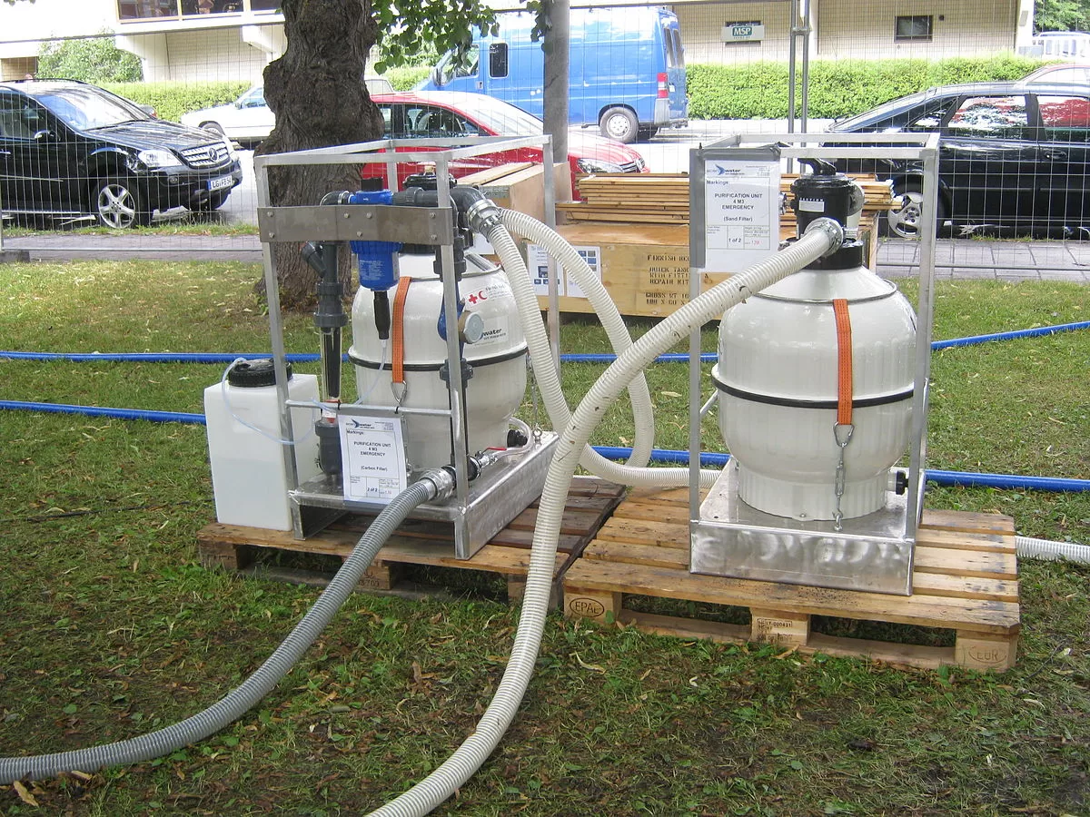 Two water purification units on wooden pallets.