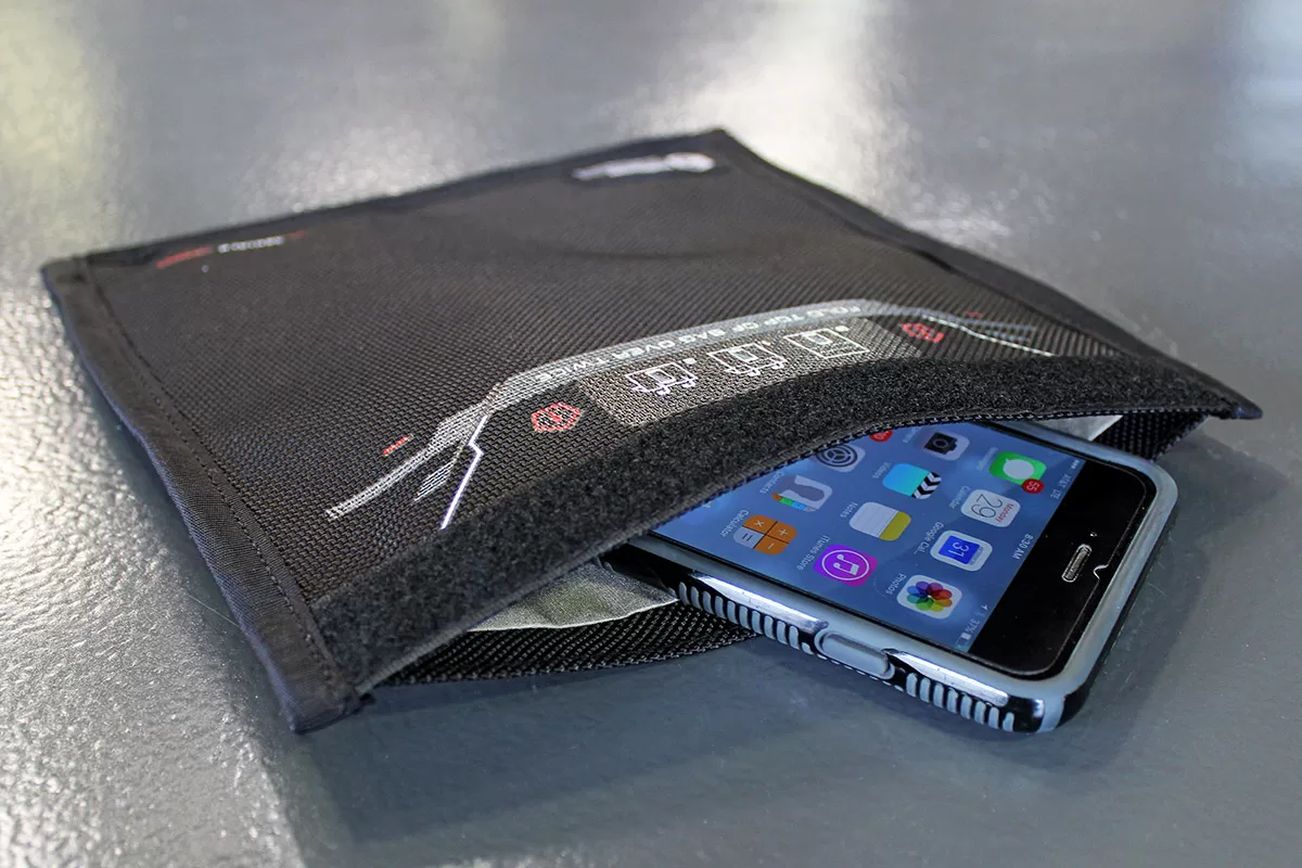 Black pouch with smartphone partially inside