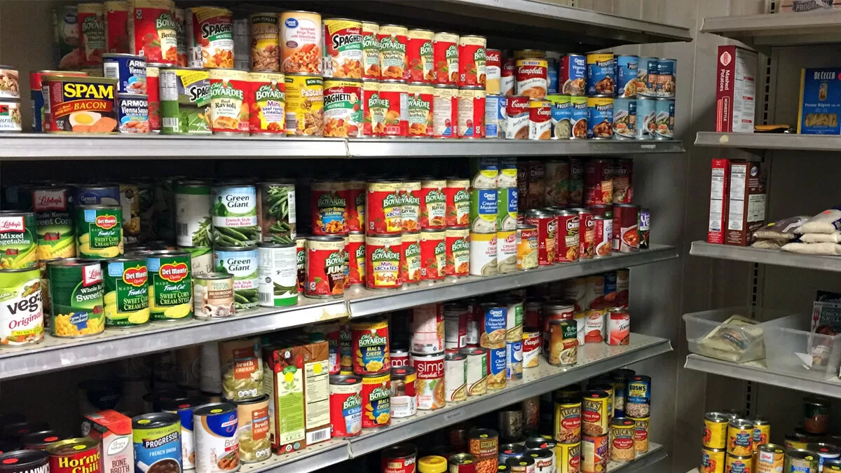 Shelves stocked with various canned food items.