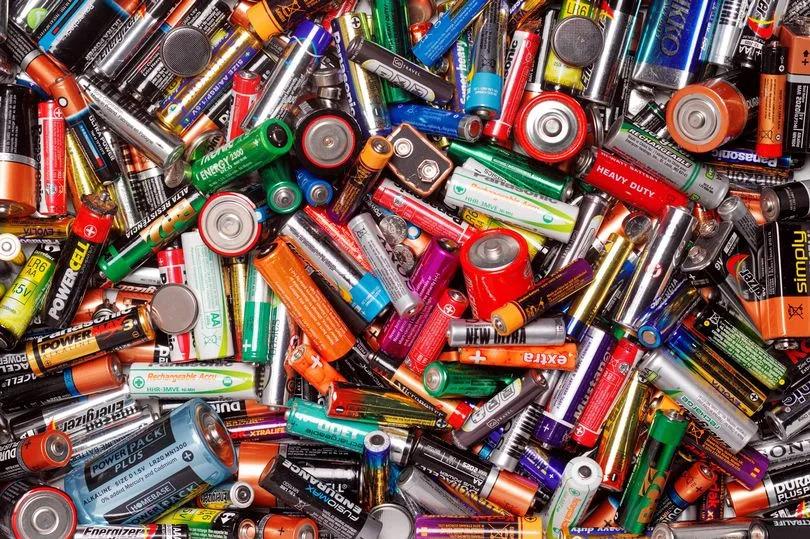 Colorful assortment of various batteries piled together.